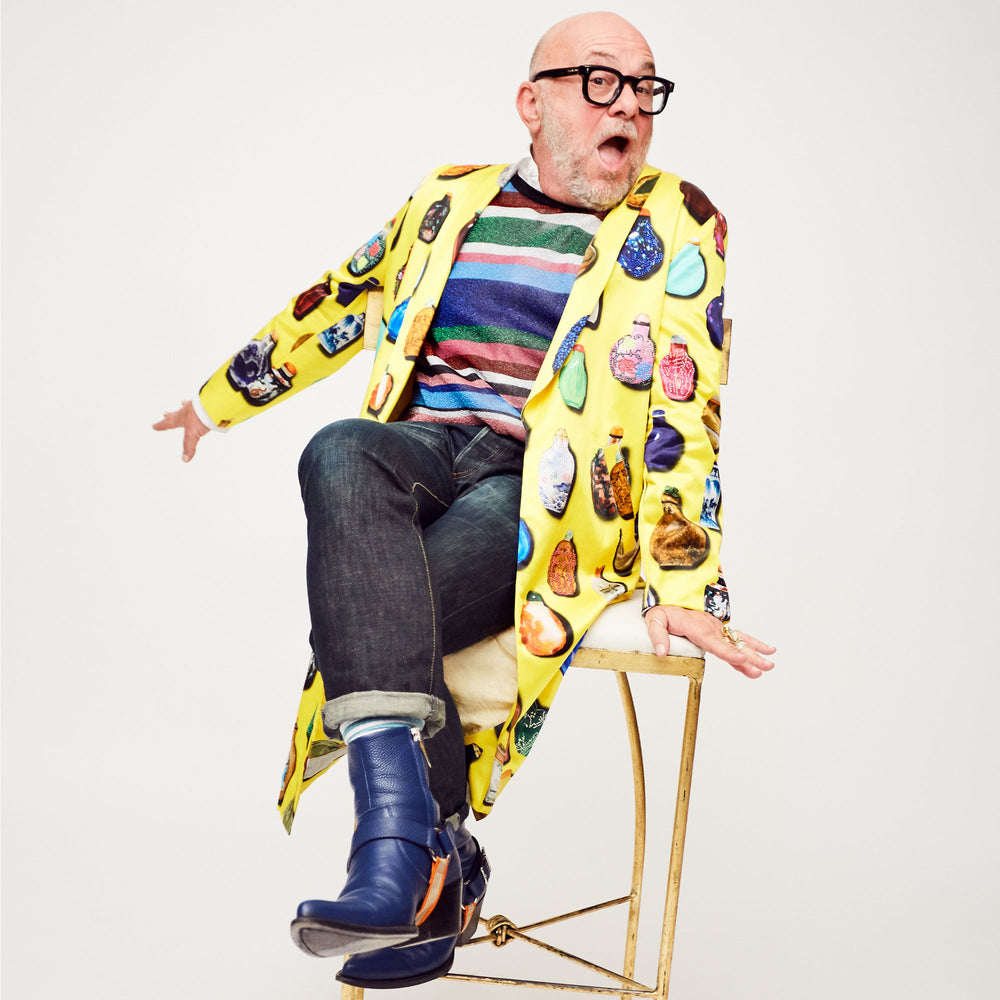 Eric Buterbaugh, with yelow coat, sitting in a chair.